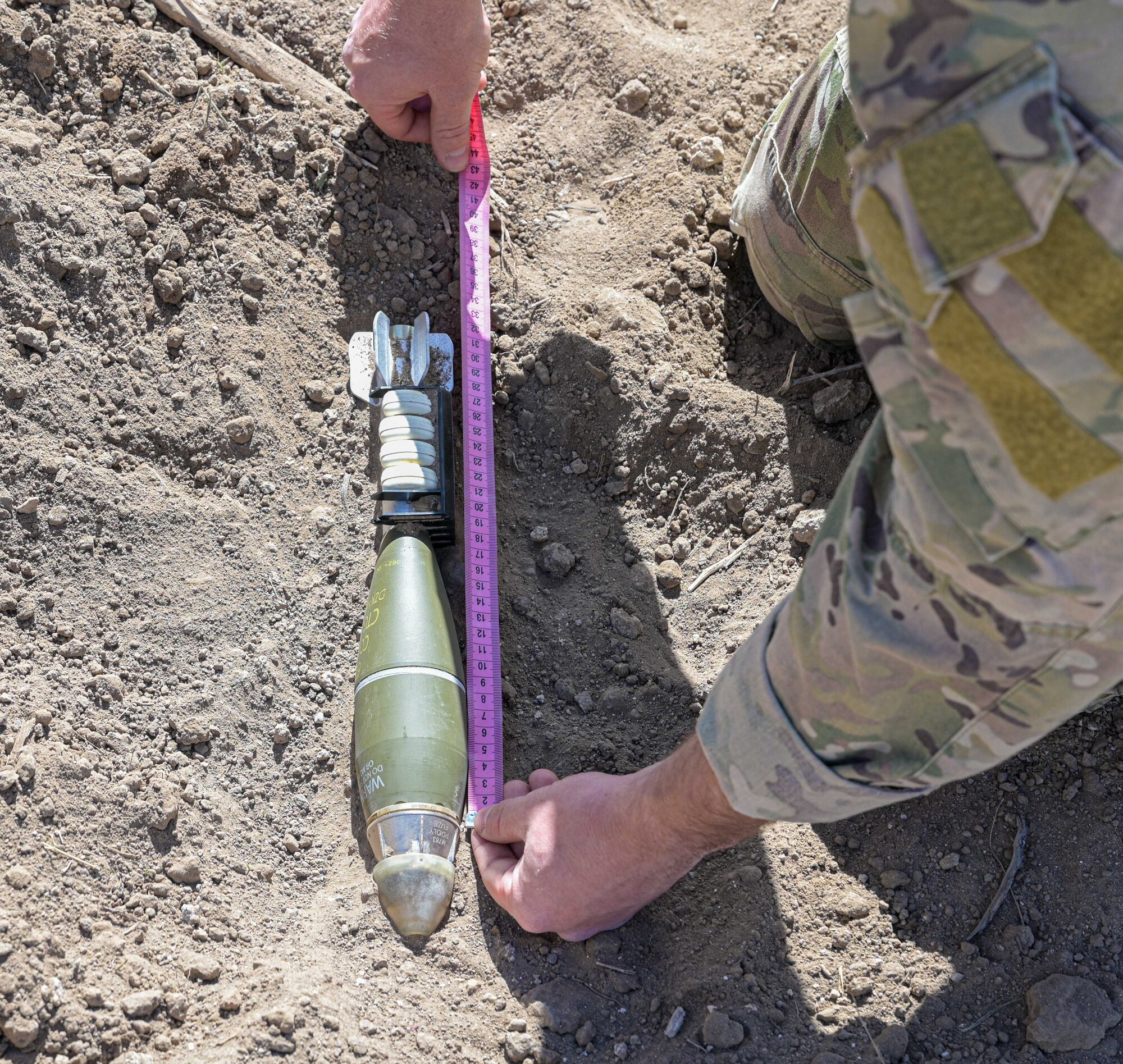 EOD Airman measures explosive.