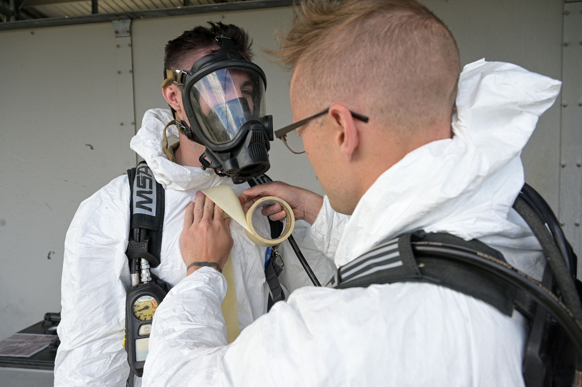 Airmen put on protective gear.