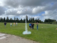 A group of students from Ridgetop Middle School’s ‘Introduction to Engineering’ course test launch a model rocket during an early-June event in Silverdale, Washington. Strategic Weapons Facility-Pacific (SWFPAC) Science, Technology, Engineering, and Math (STEM) program volunteers have supported four successful launches from 2023-2024, and volunteers ensure the safety of students during the rocket launches; assist with connecting launchers; fix faulty fuses; and answer questions about how rocket launches relate to SWFPAC’s real-world mission. SWPFAC is the command dedicated to assembling, maintaining, and storing TRIDENT II D5 Missiles and deploying them on fleet ballistic missile submarines (U.S. Navy Photo by Chani Wenning/Released)