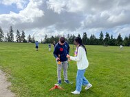 Andrew Samuelson (front left) a Strategic Weapons Facility-Pacific (SWFPAC) Science, Technology, Engineering, and Math (STEM) volunteer, assists a student with a test rocket during a launch event with Ridgetop Middle School in early June. SWFPAC’s STEM program has supported four successful launches from 2023-2024, and volunteers ensure the safety of students during the rocket launches; assist with connecting launchers; fix faulty fuses; and answer questions about how rocket launches relate to SWFPAC’s real-world mission. SWPFAC is the command dedicated to assembling, maintaining, and storing TRIDENT II D5 Missiles and deploying them on fleet ballistic missile submarines (U.S. Navy Photo by Chani Wenning/Released)