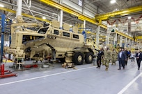 Soldiers looking at big equipment.