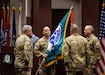 Soldier accepting flag on stage.