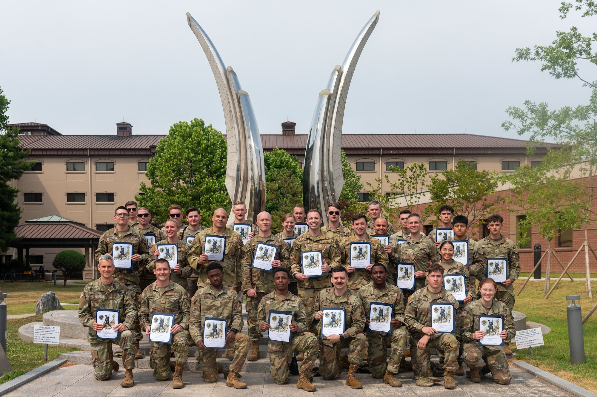U.S. service members pose for a photo after being awarded a Norwegian Foot March Foreign Military Badge at Osan Air Base, Republic of Korea, June 21, 2024. The Norwegian Foot March or Marsjmerket, is a military endurance challenge where participants march or run 30 kilometers while carrying a rucksack of 24 pounds. (U.S. Air Force photo by Senior Airman Kaitlin Frazier)