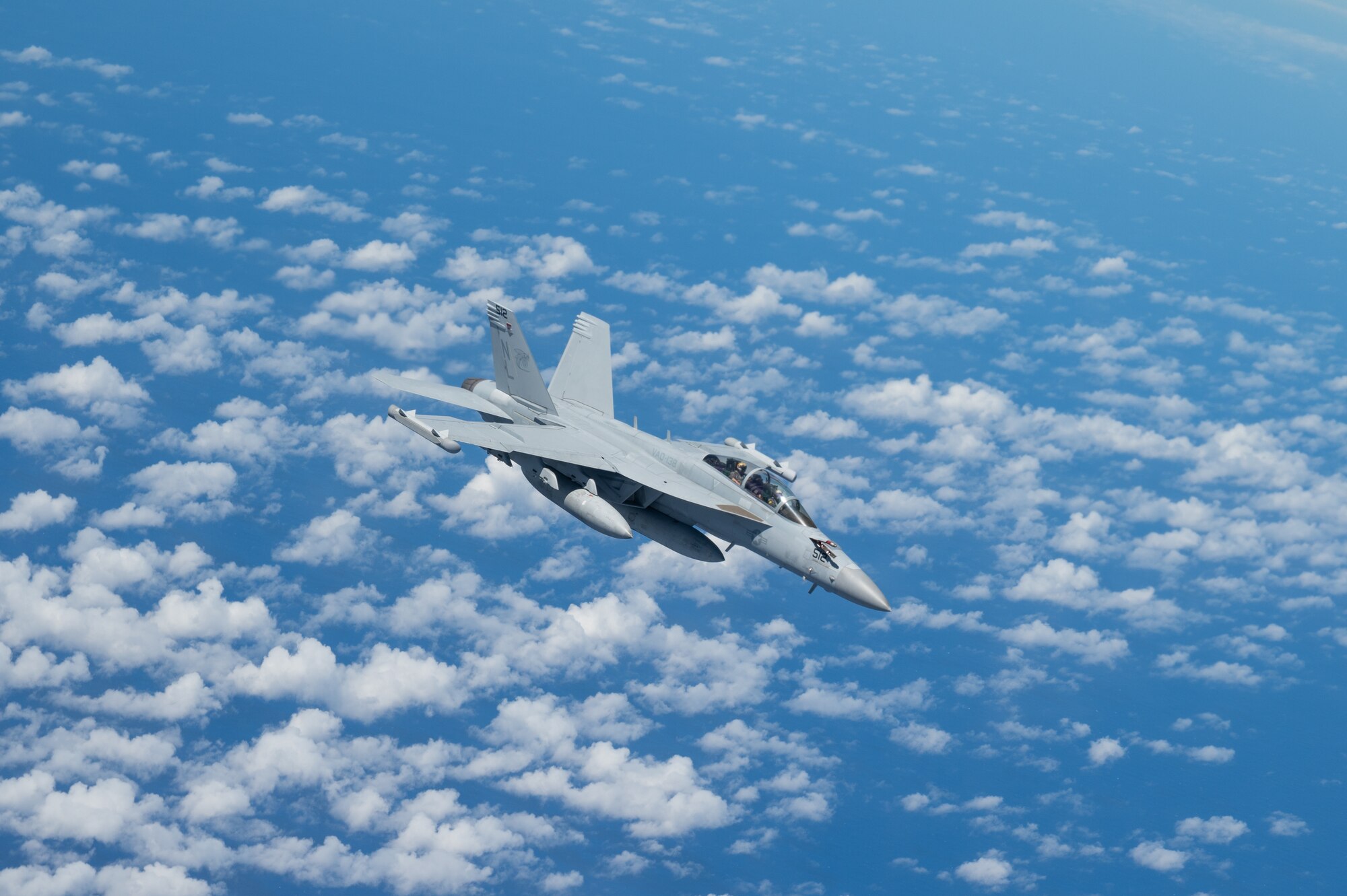An EA-18 flies over the Pacific Ocean.