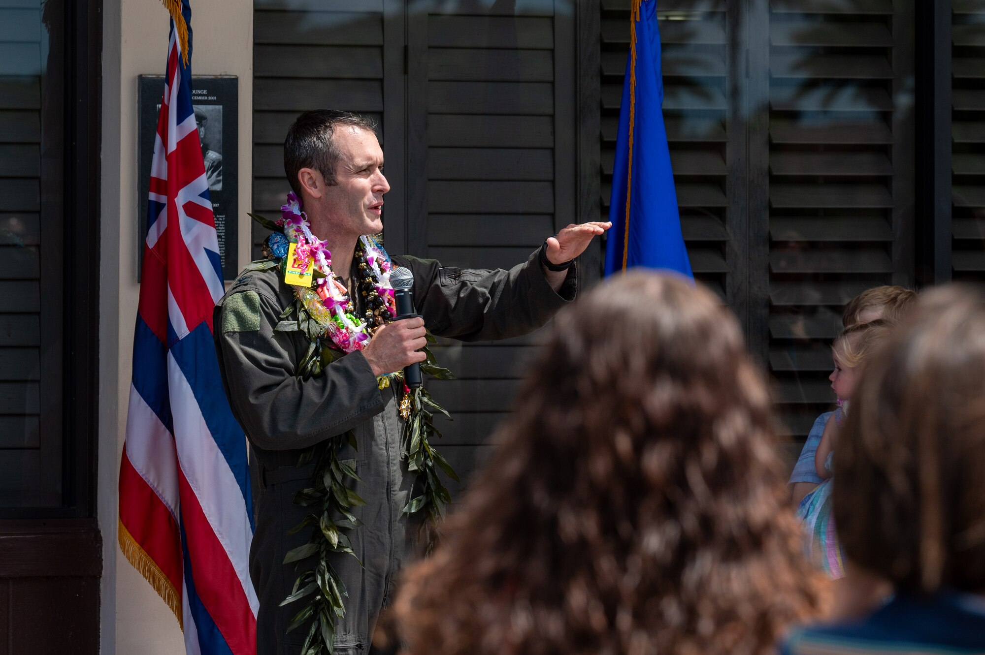 Airman speaks with microphone.