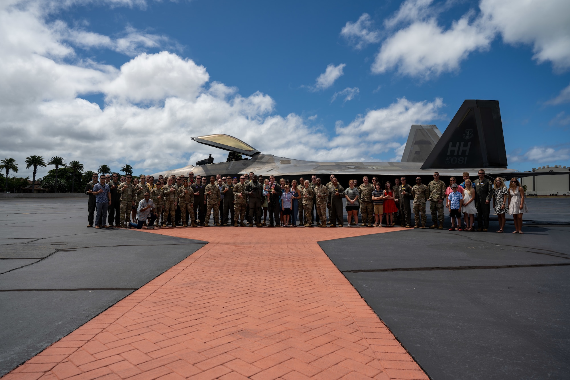 Group photo in front of aircraft.