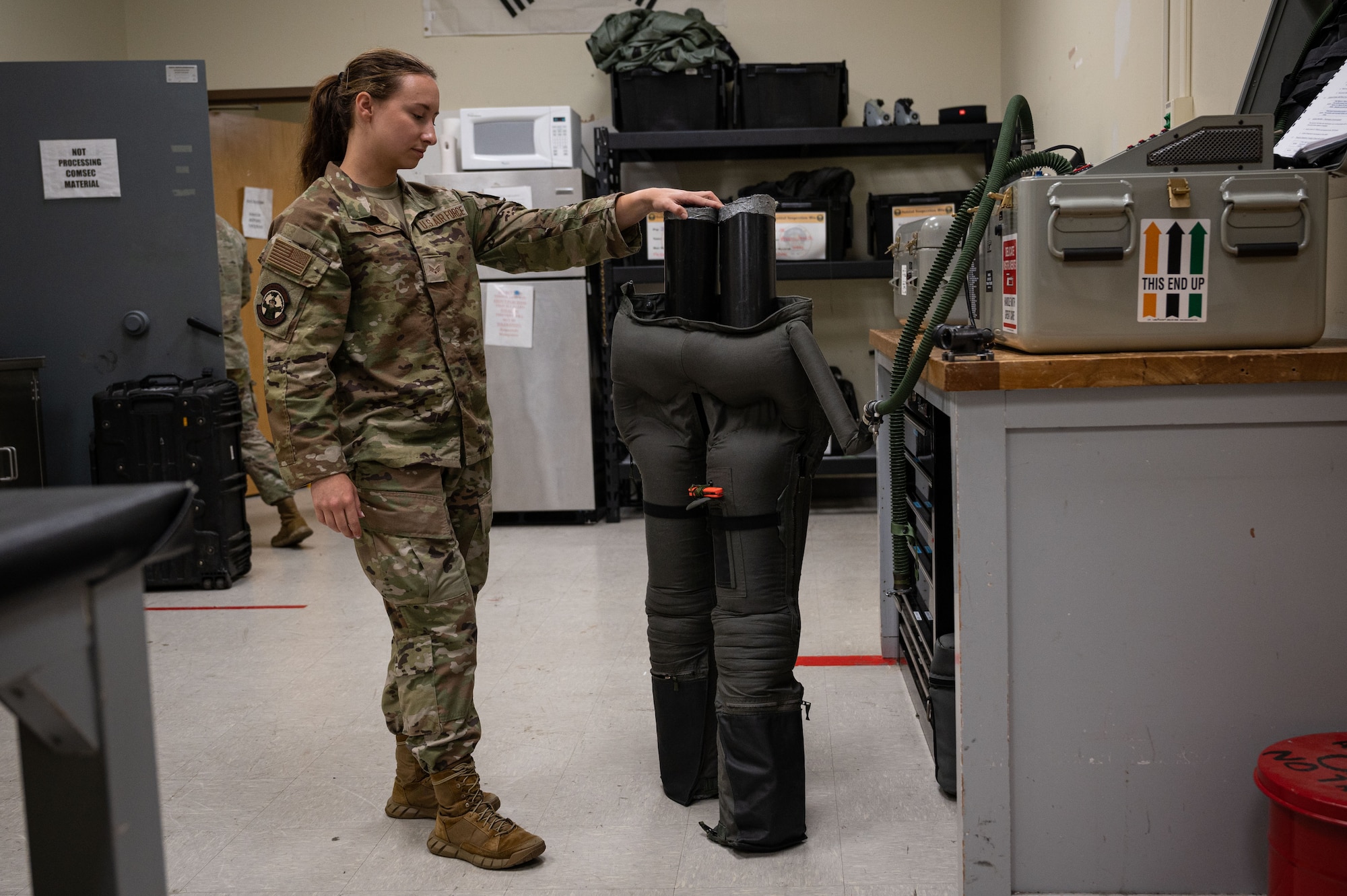 Senior Airman Madison Gang, 8th Operations Support Squadron aircrew flight equipment journeyman, inflates an anti-gravity suit with a joint combined aircrew systems tester.