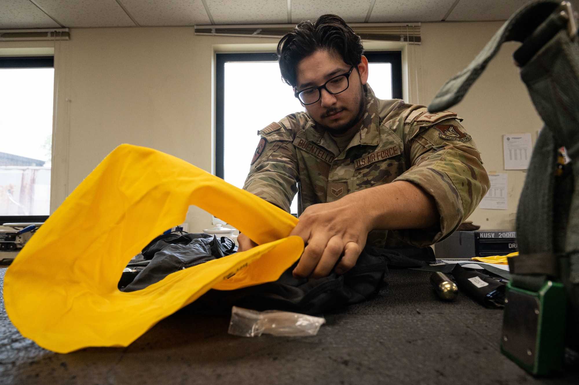 Senior Airman Alejandro Buentello, 8th Operations Support Squadron aircrew flight equipment technician, prepares a life preserver unit.