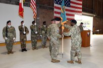 Army Col. Ernest Lane II, the commander of the 405th Army Field Support Brigade, passes the Army Field Support Battalion-Africa colors to incoming commander Lt. Col. Ross Hertlein during the AFSBn-Africa Change of Command Ceremony June 21 at Leghorn Army Depot in Livorno, Italy. (Photo by Elena Baladelli, Training Support Activity Europe)