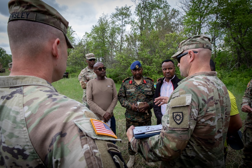 U.S. Army Maj. George Meacham (far right), the operations officer for the 206th Engineer Battalion, talks with engineer officers of the Djibouti Armed Forces (DAF) at Camp Dodge, Iowa on May 14, 2024. The DAF visited the Kentucky Army National Guard's 206th Engineer Battalion's annual training to learn ideas on how to set up battalion level engineer operations. (U.S. Army National Guard photo by Sgt. 1st Class Andrew Dickson)