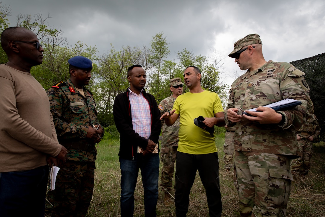 U.S. Army Maj. George Meacham (far right), the operations officer for the 206th Engineer Battalion, talks with engineer officers of the Djibouti Armed Forces (DAF) at Camp Dodge, Iowa on May 14, 2024. The DAF visited the Kentucky Army National Guard's 206th Engineer Battalion's annual training to learn ideas on how to set up battalion level engineer operations. (U.S. Army National Guard photo by Sgt. 1st Class Andrew Dickson)