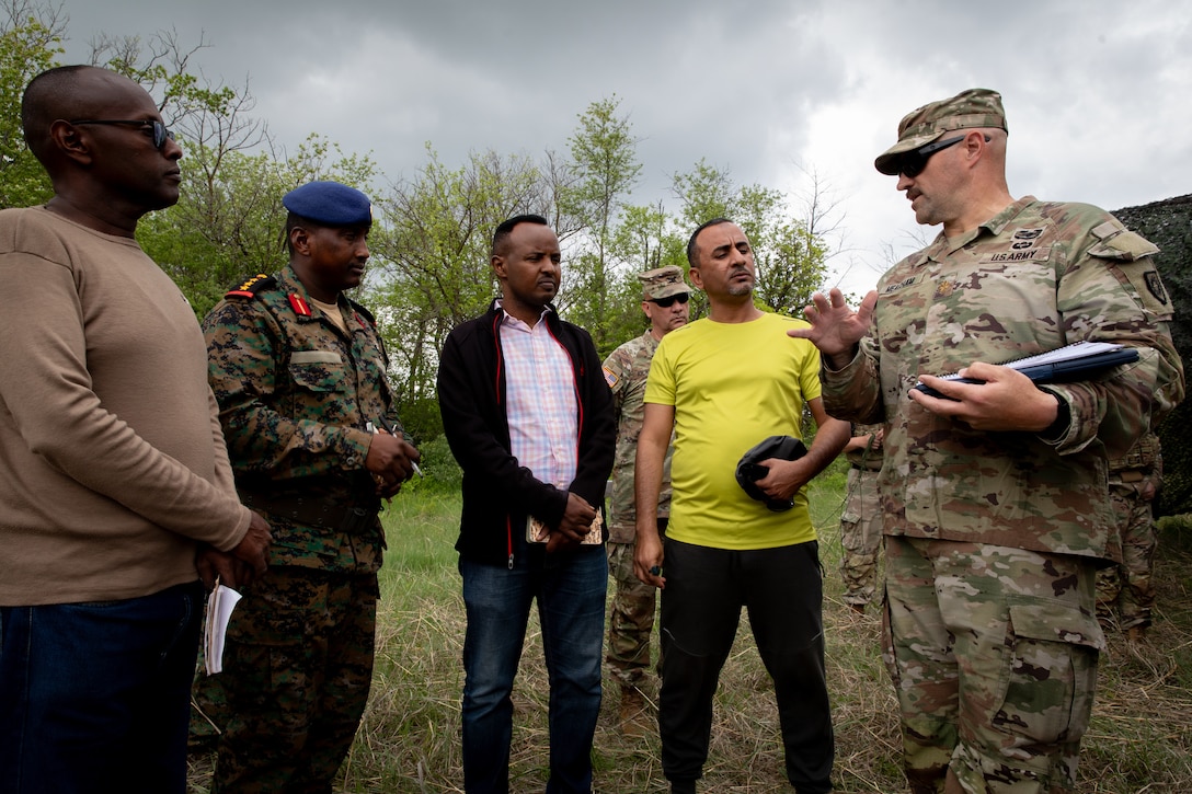 U.S. Army Maj. George Meacham (far right), the operations officer for the 206th Engineer Battalion, talks with engineer officers of the Djibouti Armed Forces (DAF) at Camp Dodge, Iowa on May 14, 2024. The DAF visited the Kentucky Army National Guard's 206th Engineer Battalion's annual training to learn ideas on how to set up battalion level engineer operations. (U.S. Army National Guard photo by Sgt. 1st Class Andrew Dickson)