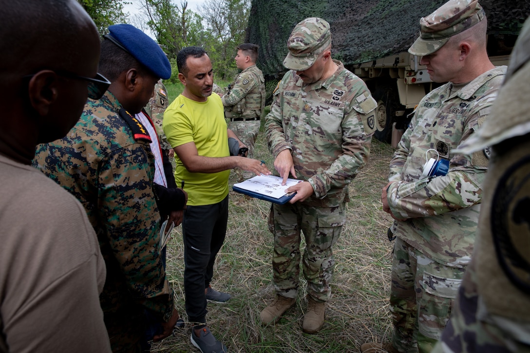 U.S. Army Maj. George Meacham, the operations officer for the 206th Engineer Battalion, explains a battalion level command post set up with engineer officers of the Djibouti Armed Forces (DAF) at Camp Dodge, Iowa on May 14, 2024. The DAF visited the Kentucky Army National Guard's 206th Engineer Battalion's annual training to learn ideas on how to set up battalion level engineer operations. (U.S. Army National Guard photo by Sgt. 1st Class Andrew Dickson)