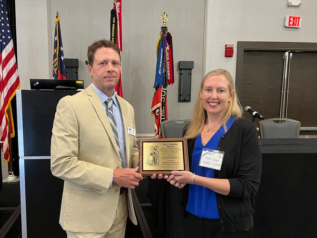 Photo of SAME Savannah Post President, David Nelson presenting the 2024 James Connolly Award to Kate Dixon, design branch chief of the Engineering Division for the U.S. Army Corps of Engineers, Savannah District, at the Marriott Riverfront in Savannah, Georgia, June 27, 2024.