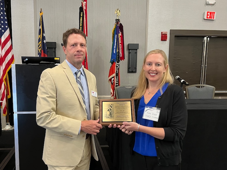 Photo of SAME Savannah Post President, David Nelson presenting the 2024 James Connolly Award to Kate Dixon, design branch chief of the Engineering Division for the U.S. Army Corps of Engineers, Savannah District, at the Marriott Riverfront in Savannah, Georgia, June 27, 2024.