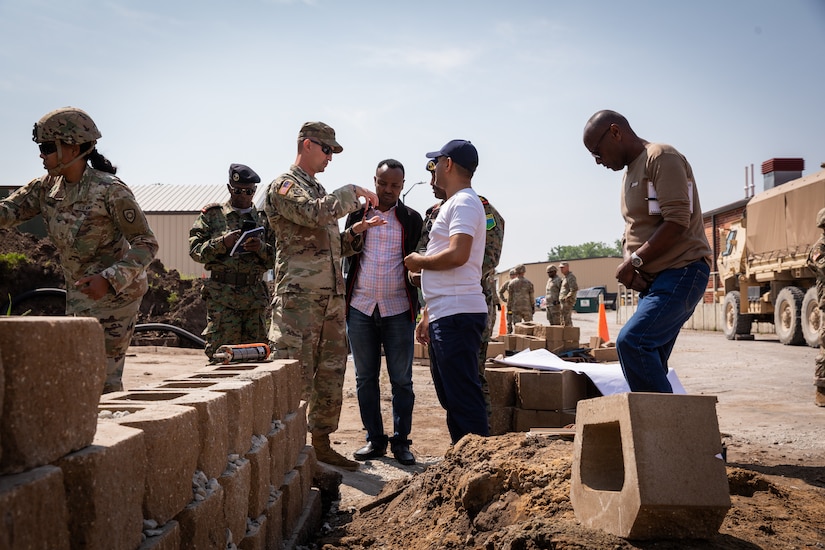 U.S. Army Capt. Colby Davis, the commander of the 130th Engineer Support Company explains the planning phases of construction projects to engineer officers of the Djibouti Armed Forces (DAF) at Camp Dodge, Iowa on May 15, 2024. The DAF visited the Kentucky Army National Guard's 206th Engineer Battalion's annual training to learn ideas on how to set up battalion level engineer operations. (U.S. Army National Guard photo by Sgt. 1st Class Andrew Dickson)