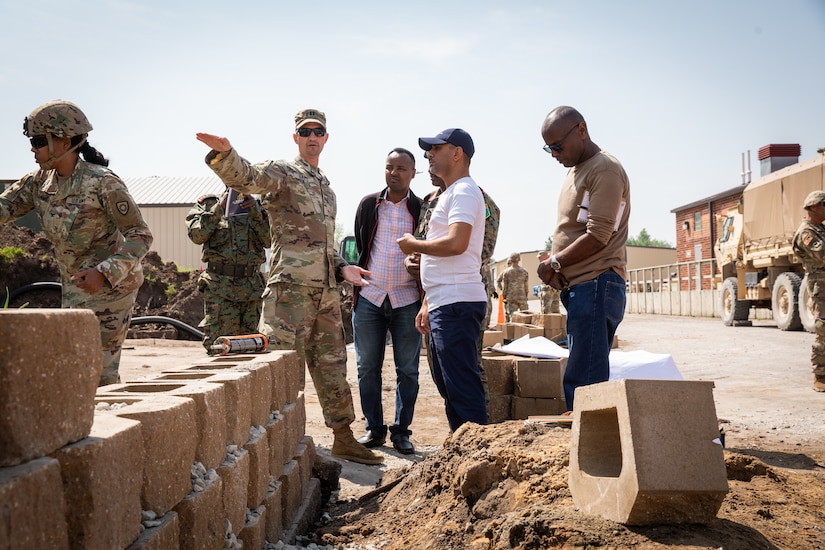 U.S. Army Capt. Colby Davis, the commander of the 130th Engineer Support Company explains the planning phases of construction projects to engineer officers of the Djibouti Armed Forces (DAF) at Camp Dodge, Iowa on May 15, 2024. The DAF visited the Kentucky Army National Guard's 206th Engineer Battalion's annual training to learn ideas on how to set up battalion level engineer operations. (U.S. Army National Guard photo by Sgt. 1st Class Andrew Dickson)