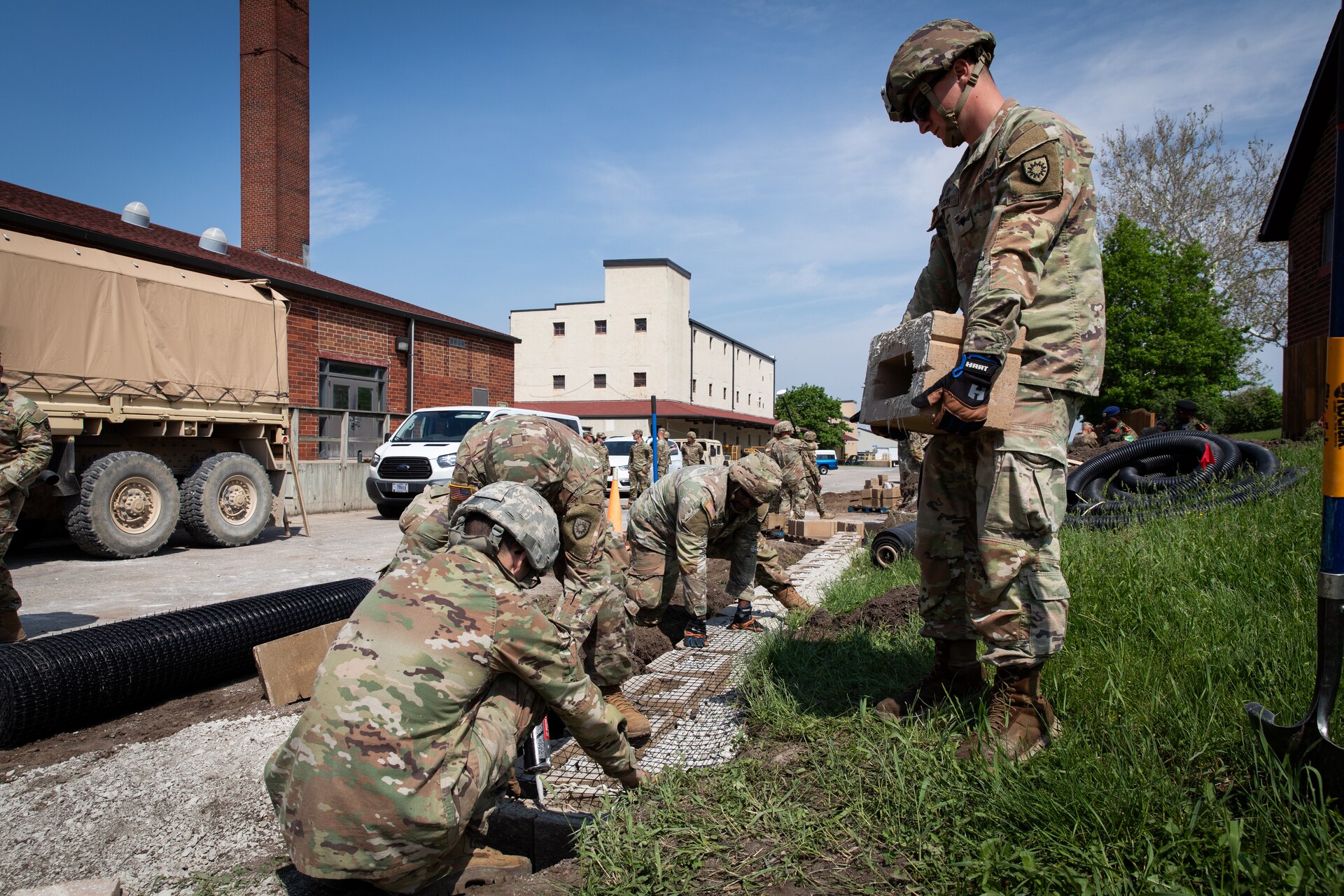 Engineers with the 130th Engineer support Company, 206th Engineer Battalion, Kentucky National Guard, constructing a retaining wall at Camp Dodge, Iowa on May 15, 2024. The 206th Engineer Battalion worked on various construction projects at Camp Dodge for their annual training.  (U.S. Army National Guard photo by Sgt. 1st Class Andrew Dickson)