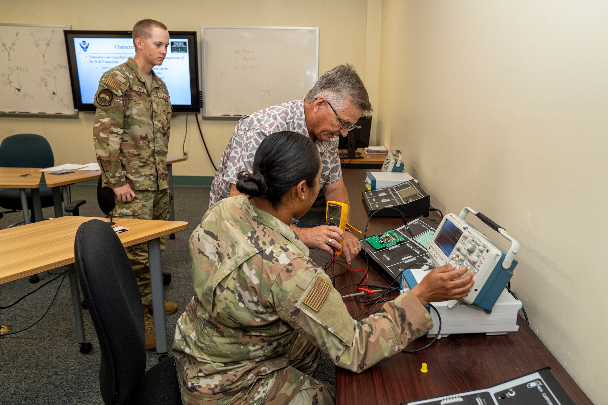 U.S. Air Force Ret. Senior Master Sgt. James Chapman, 334th Training Squadron Radar, Airfield & Weather Systems Specialist instructor, advises Airman 1st Class Rocio Trejo, 334th TRS RAWS student, during a practical application assignment on Keesler Air Force Base, Mississippi, June 20, 2024.