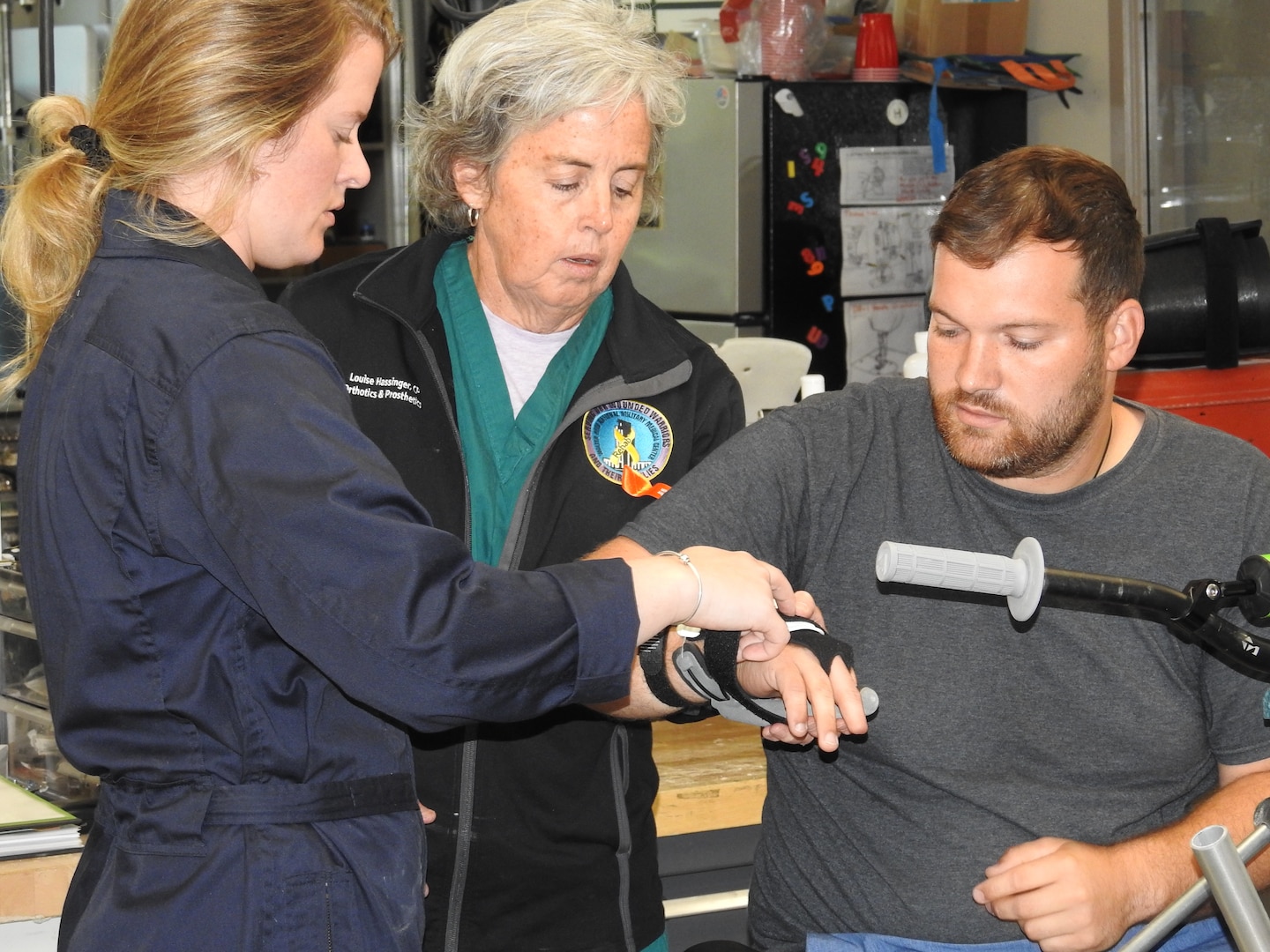 Walter Reed's Abigail Hinson (left), prosthetic technician in the Orthotics and Prosthetics Lab, and Louise Hassinger, prosthesis technology specialist, are working with the medical center's 3D Medical Applications Center on a special prosthetic designed for Ryan Pelzer to help him shift gears and get back into motocross racing.