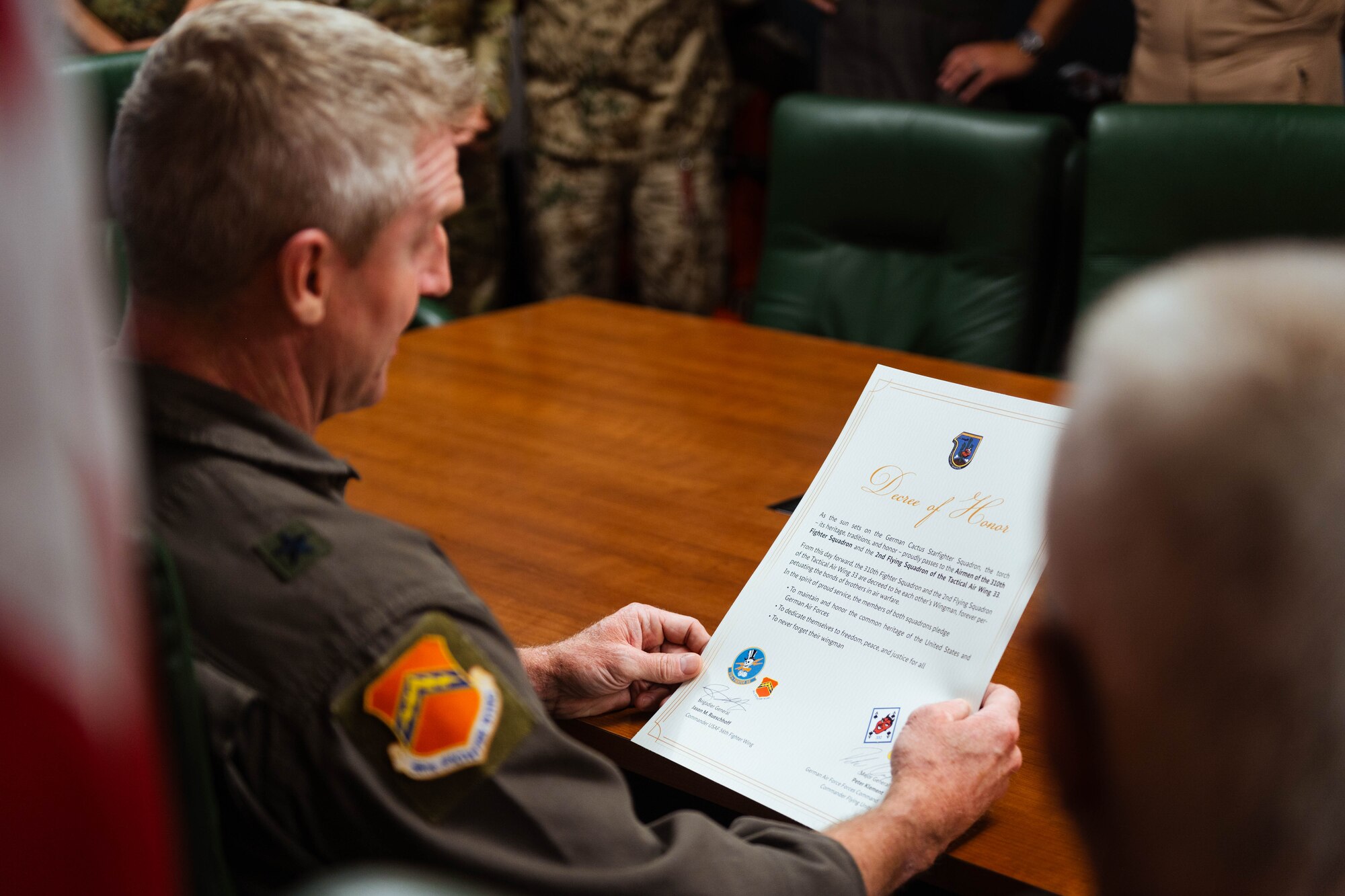 U.S. Air Force Brig. Gen. Jason Rueschhoff, 56th Fighter Wing commander, reads a decree of honor between the Airmen of the 310th Fighter Squadron and the 2nd Flying Squadron of the Tactical Air Wing 33 following its signing.