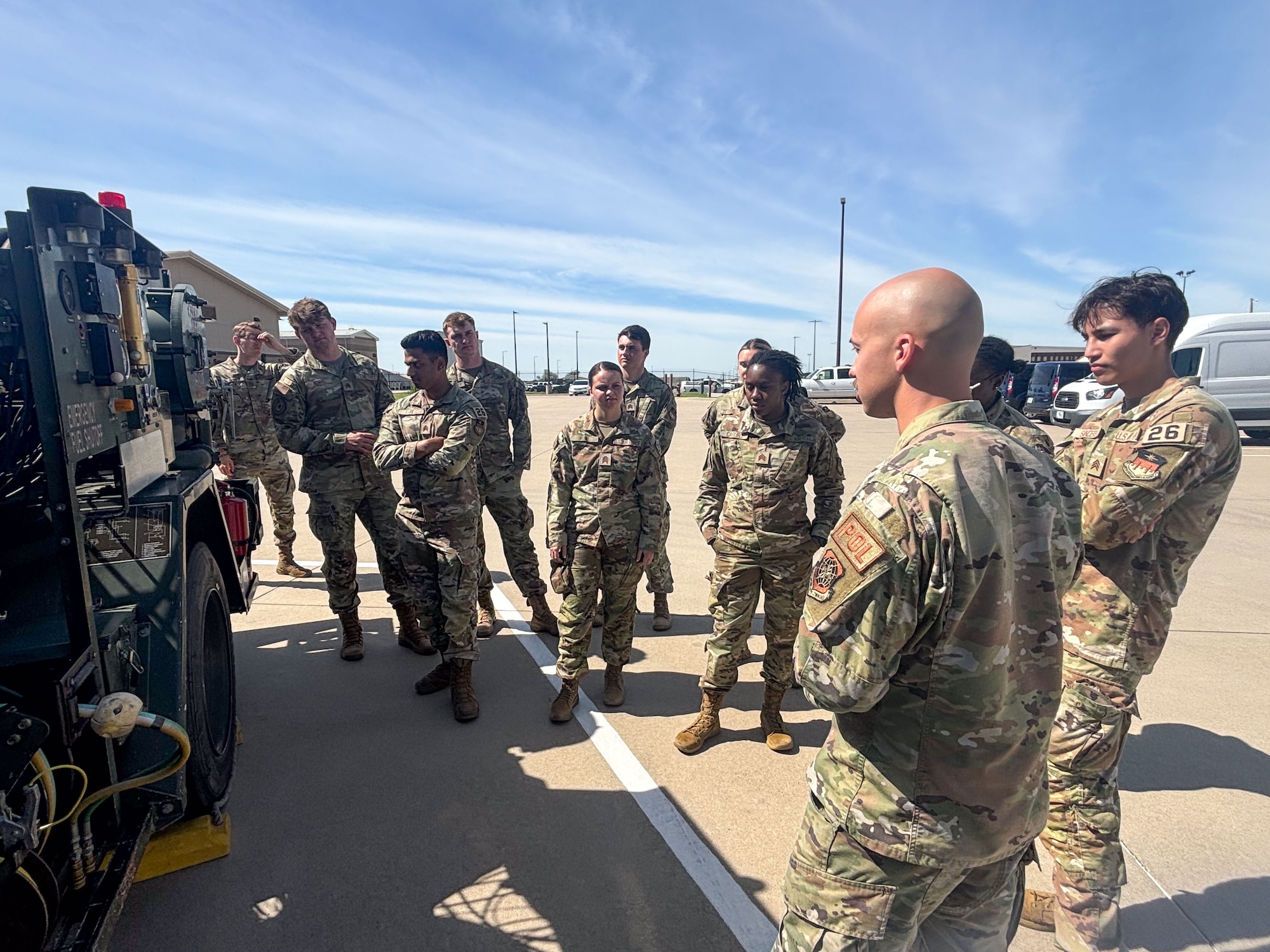 Senior Airman Justin Hodges, 22nd Logistics Readiness Squadron fuels management journeyman, shows cadets from the U.S. Air Force Academy the different fuel trucks June 10, 2024, at McConnell Air Force Base, Kansas. During Operation Air Force, nine cadets visited the base and spent three weeks immersing themselves in the operational Air Force.