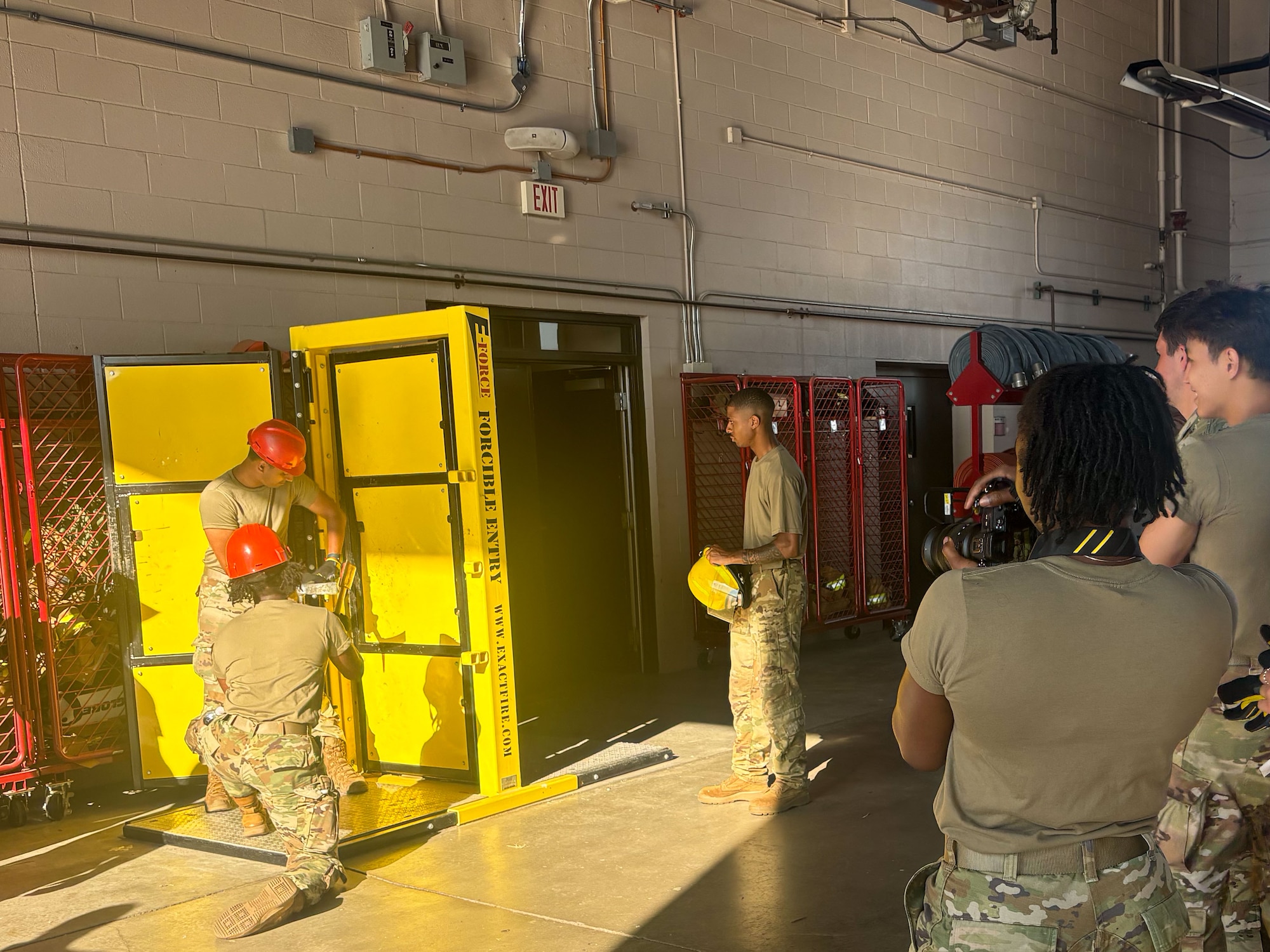 Cadet 2nd class Madison Carlisle, U.S. Air Force Academy student (right), takes photos of fellow cadets at the McConnell Fire Department, June 13, 2024, at McConnell Air Force Base, Kansas. The cadets toured the Fire House to get a look at the different vehicles, view the emergency management hub and learn how to break through doors.