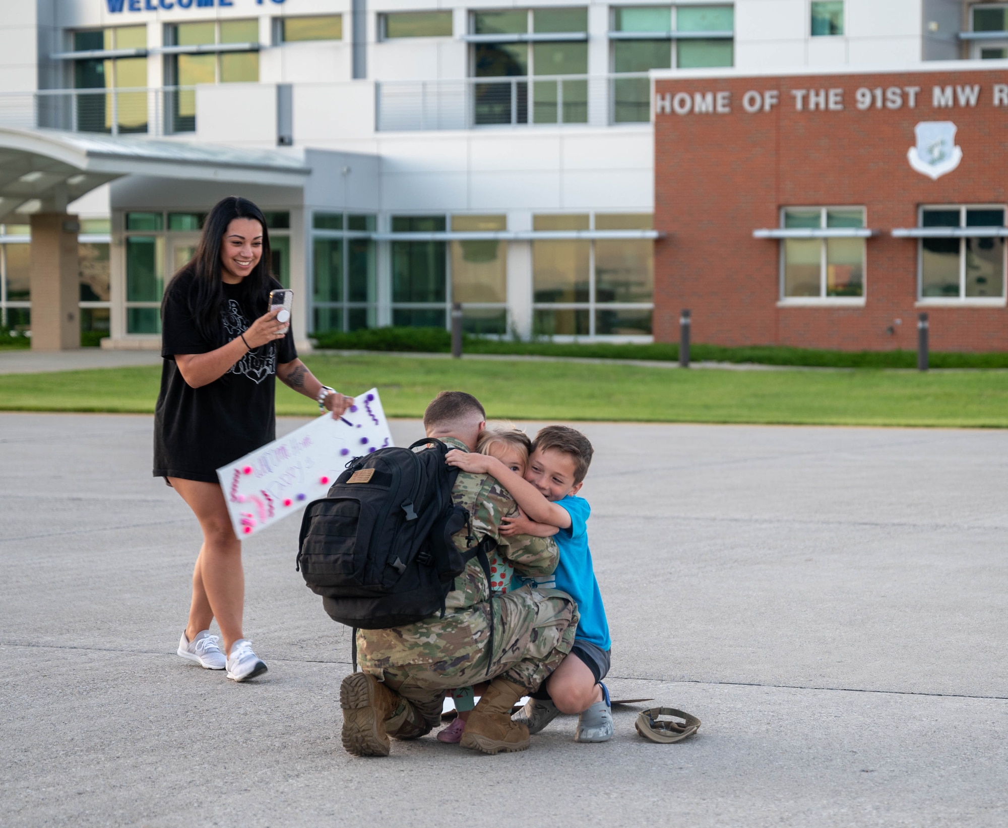 A U.S. Airman assigned to the 5th Bomb Wing reunites with family after returning from Bomber Task Force (BTF) 24-3 at Minot Air Force Base, North Dokata, June 26, 2024. U.S. Strategic Command BTF missions provide opportunities to train and work with allies and partners in joint and coalition operations and exercises. (U.S. Air Force photo by Airman 1st Class Luis Gomez)