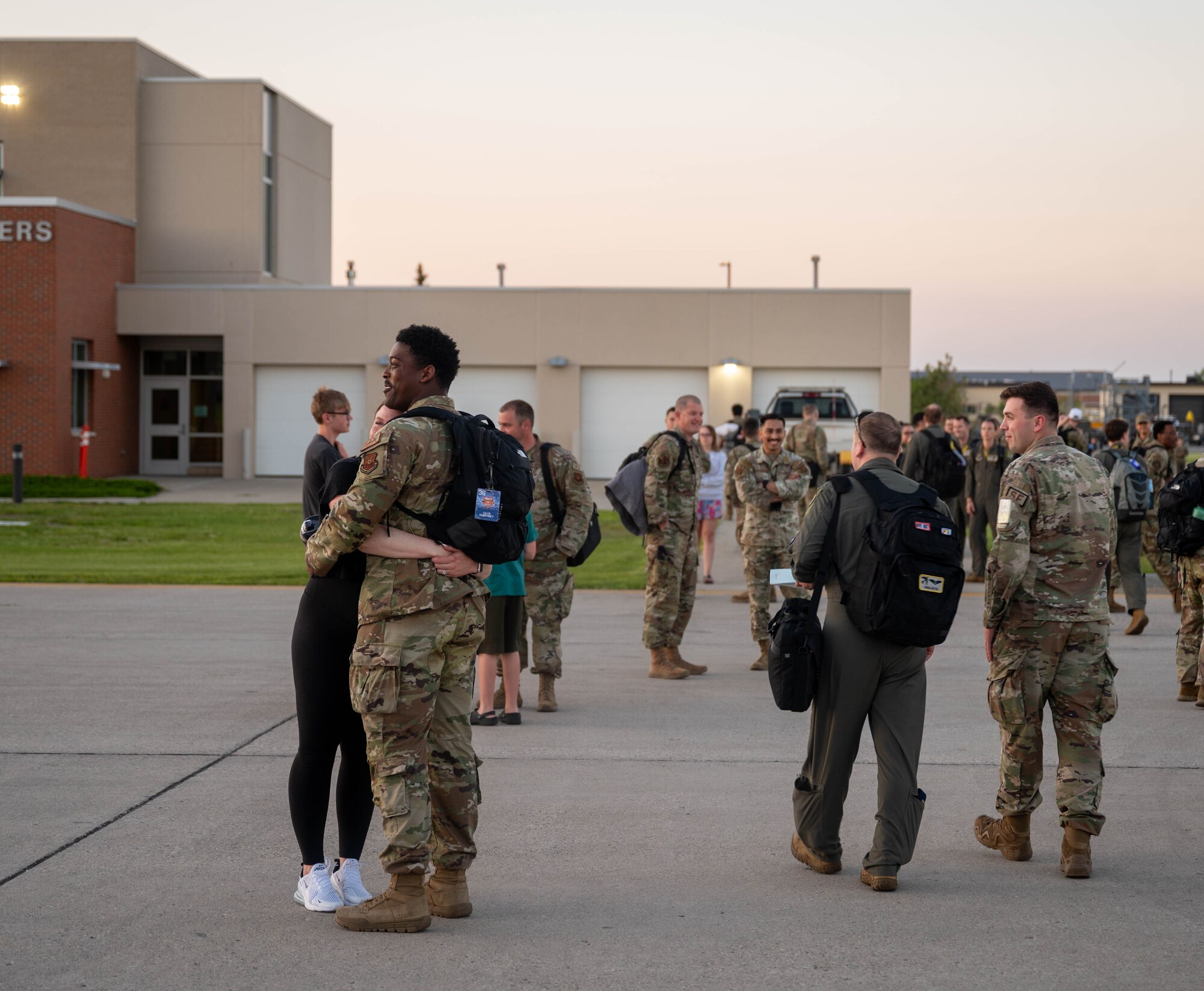 U.S. Airmen assigned to the 5th Bomb Wing are greeted by colleagues and family after returning from Bomber Task Force 24-3 at Minot Air Force Base, North Dakota, June 26, 2024. The Airmen spent six weeks at Royal Air Force Fairford, England, as part of a routine deployment to the U.S. Air Forces Europe – Air Forces Africa area of responsibility. (U.S. Air Force photo by Airman 1st Class Luis Gomez)