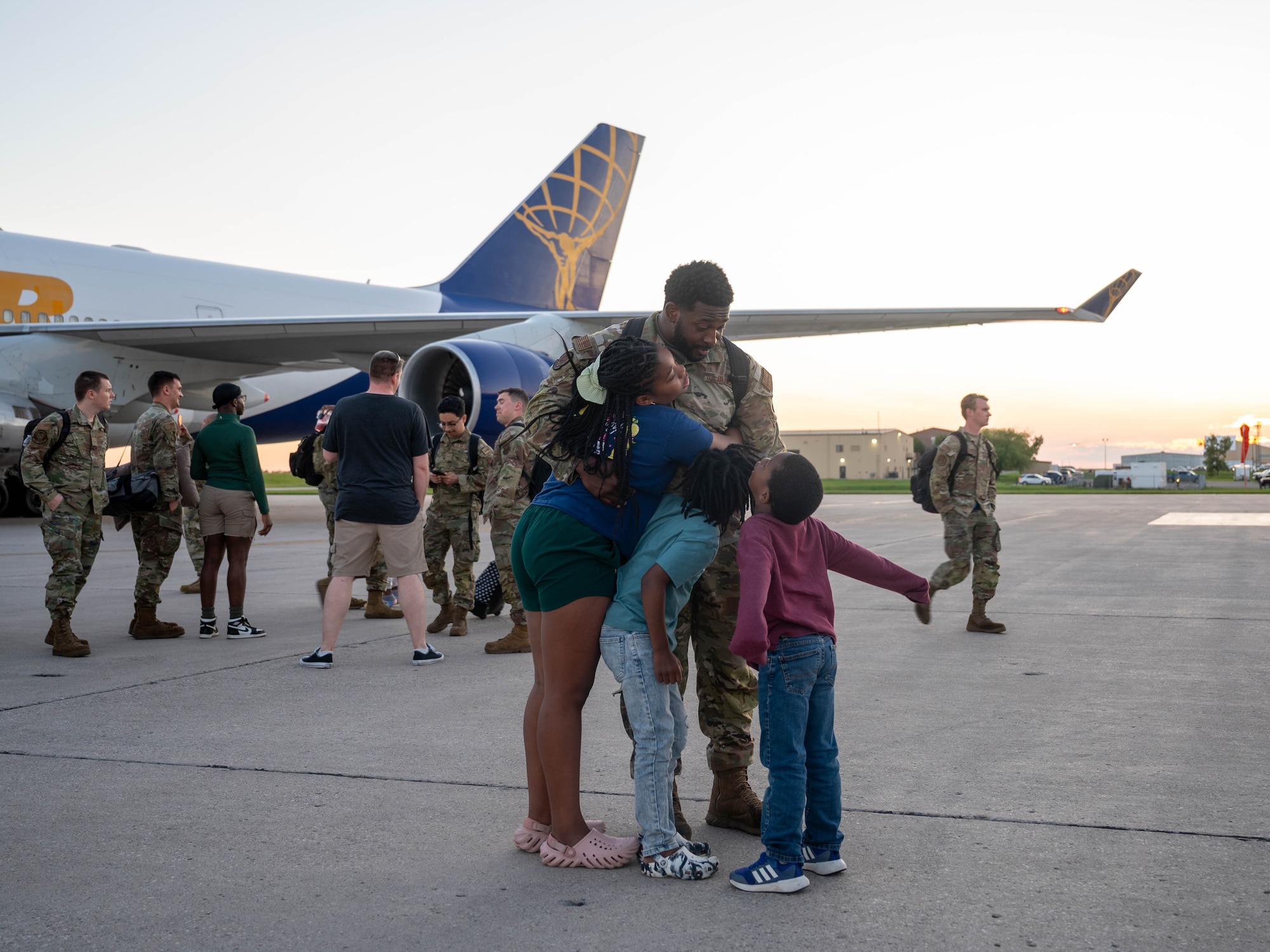 A U.S. Airman assigned to the 5th Bomb Wing reunites with family after returning from Bomber Task Force (BTF) 24-3 at Minot Air Force Base, North Dakota, June 26, 2024. BTF missions demonstrate the credibility U.S. our forces to address a global security environment that is more diverse and uncertain than at any other time in recent history. (U.S. Air Force photo by Airman 1st Class Luis Gomez)