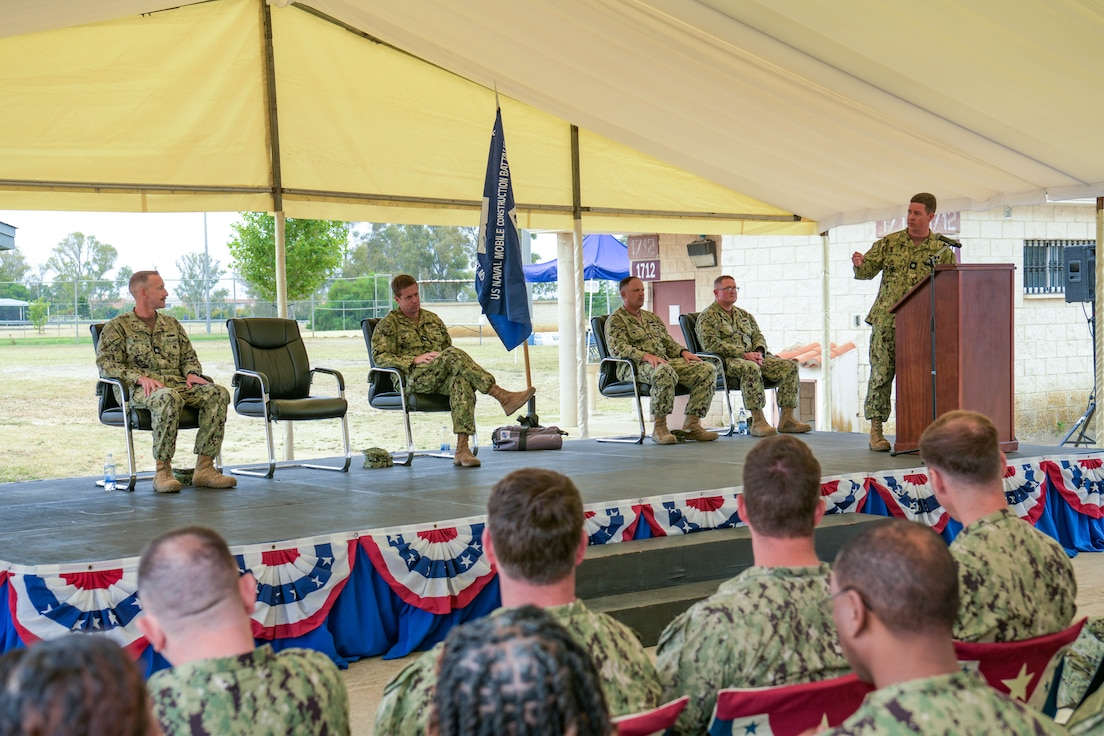 Cmdr. James Angerman, commander, Naval Mobile Construction Battalion (NMCB) 11 left, gives his first address as NMCB-11's commanding officer during the battalion's change of command ceremony onboard Naval Station Rota, Spain, June 26, 2024.
