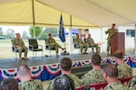 Cmdr. James Angerman, commander, Naval Mobile Construction Battalion (NMCB) 11 left, gives his first address as NMCB-11's commanding officer during the battalion's change of command ceremony onboard Naval Station Rota, Spain, June 26, 2024.