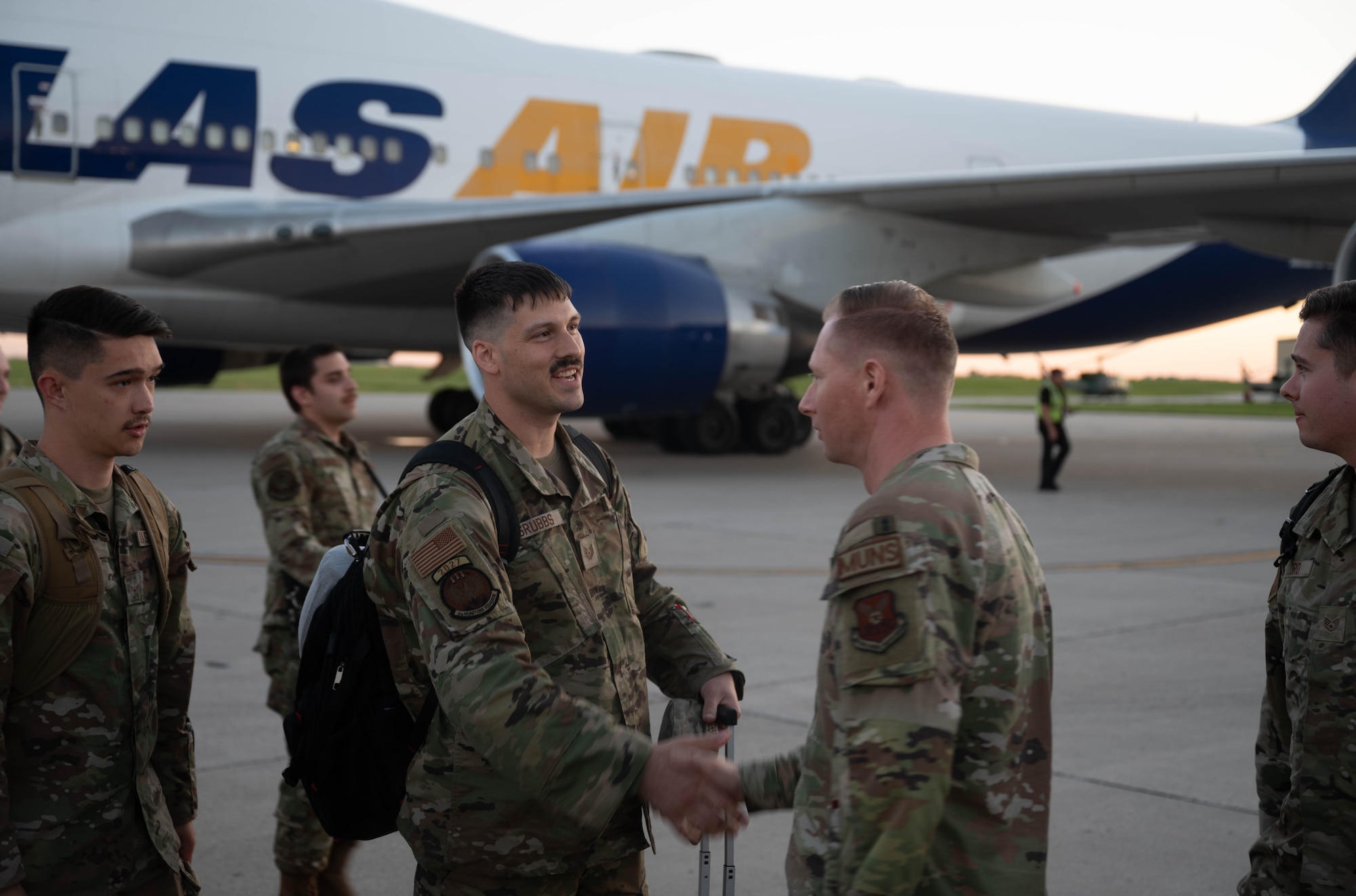 A U.S. Airman assigned to the 5th Bomb Wing is greeted after returning from Bomber Task Force (BTF) 24-3 at Minot Air Force Base, North Dakota, June 26, 2024. U.S. Strategic Command BTF missions provide opportunities to train and work with allies and partners in joint and coalition operations and exercises. (U.S. Air Force photo by Airman 1st Class Luis Gomez)