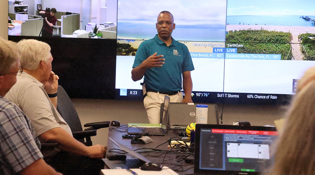 Man standing in front of a group giving a presentation.