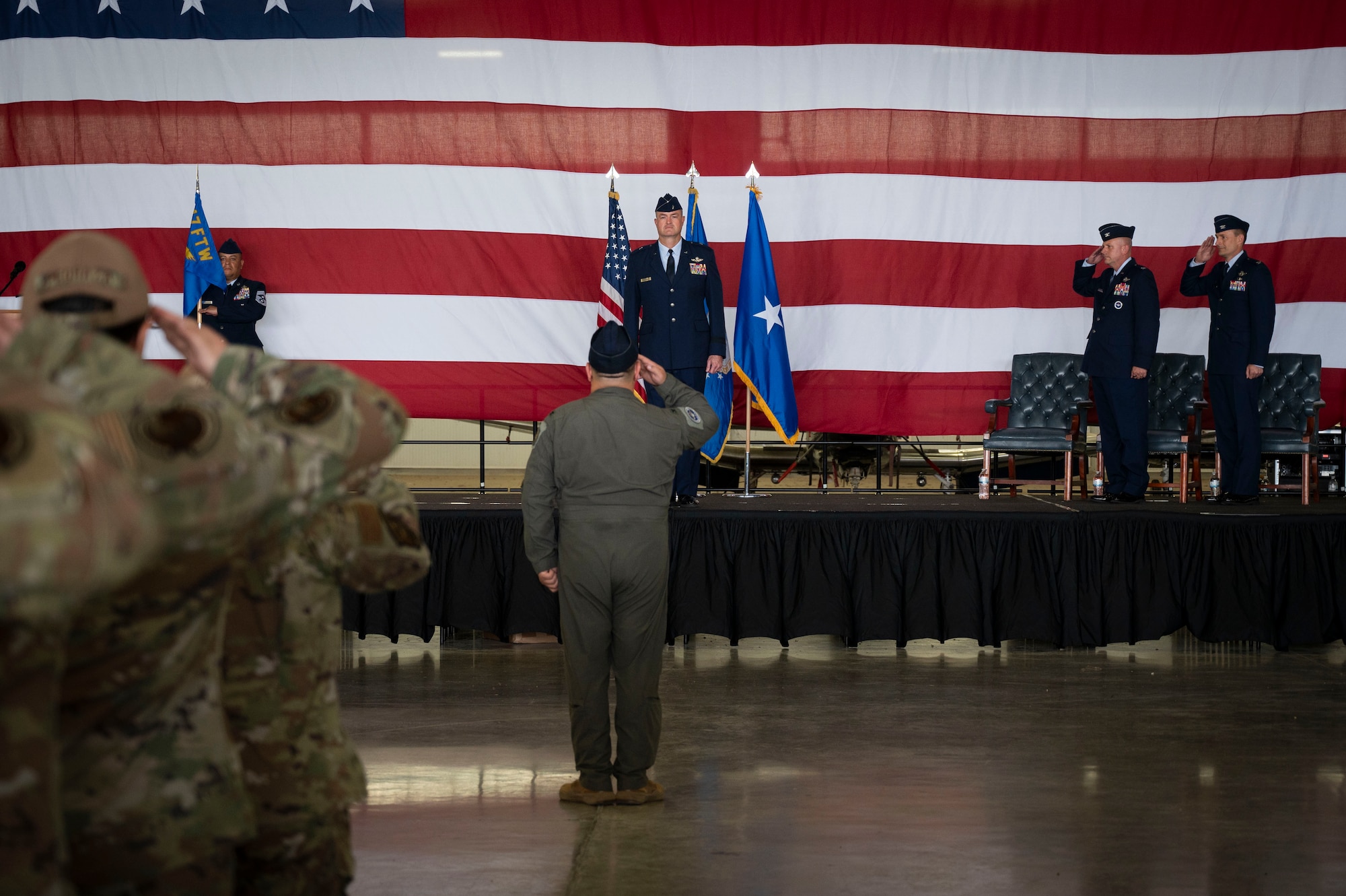 U.S. Air Force Brig. Gen. Randall Cason, Mobilization Assistant to the Commander, Nineteenth Air Force, stands at attention as he is introduced as the presiding official during the 47th Flying Training Wing change of command ceremony at Laughlin Air Force Base, Texas, June 26, 2024. Change of command ceremonies represent a formal transfer of authority and responsibility for a unit from one commanding officer to another. (U.S. Air Force photo by Senior Airman Kailee Reynolds)