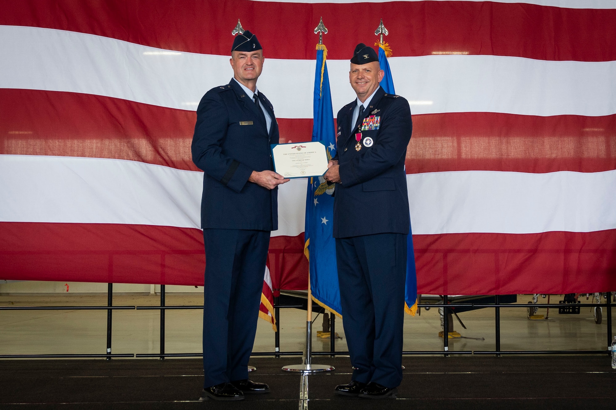U.S. Air Force Brig. Gen. Randall Cason (left), Mobilization Assistant to the Commander, Nineteenth Air Force, presents the Legion of Merit to Col. Kevin Davidson (right), former 47th Flying Training Wing (FTW) commander, during the 47th FTW change of command ceremony at Laughlin Air Force Base, Texas, June 26, 2024. As commander, Davidson oversaw nearly 2,800 military and civilian personnel engaged in executing more than 61,000 aircraft sororities yearly in support of Laughlin’s Undergraduate Pilot Training mission. (U.S. Air Force photo by Senior Airman Kailee Reynolds)