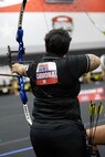 U.S. Army Spc. Berenice Carmona aims an arrow at her target during the archery event