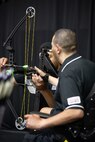 U.S. Army Cpt. Luis Avila and son Miguel Avila set up his bow