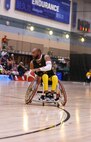 U.S. Army veteran Brent Garlic dribbles down court in a game of wheelchair basketball