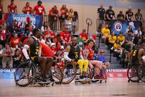 Team Army and Team Marine Corps athletes compete in a wheelchair basketball game