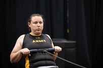 U.S. Army veteran Victoria Camire warms up prior to the indoor rowing competition