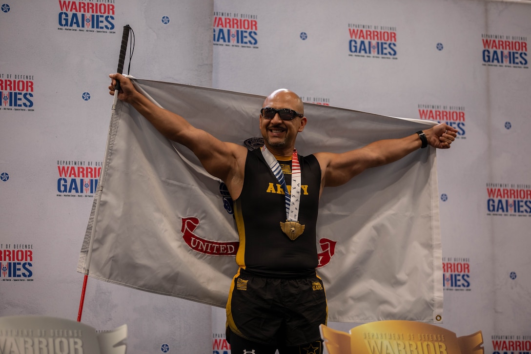 U.S. Army veteran Henry Escobedo poses for a photo after receiving gold in indoor rowing