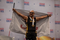 U.S. Army veteran Henry Escobedo poses for a photo after receiving gold in indoor rowing
