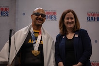 U.S. Army veteran Henry Escobedo, left poses for a photo with Dr. Agnes Gereben Schaefer, Assistant Secretary of Defense for Manpower and Reserve Affairs