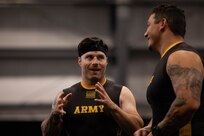 U.S. Army veteran J.P. Lane, left, talks with teammate veteran Jason Smith at the indoor rowing event
