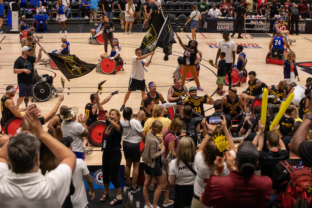 Team Army Nation and athletes celebrate winning the bronze medal wheelchair rugby match