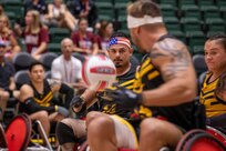 U.S. Army veteran Michael Villagran throws the ball to a teammate in a wheelchair rugby match