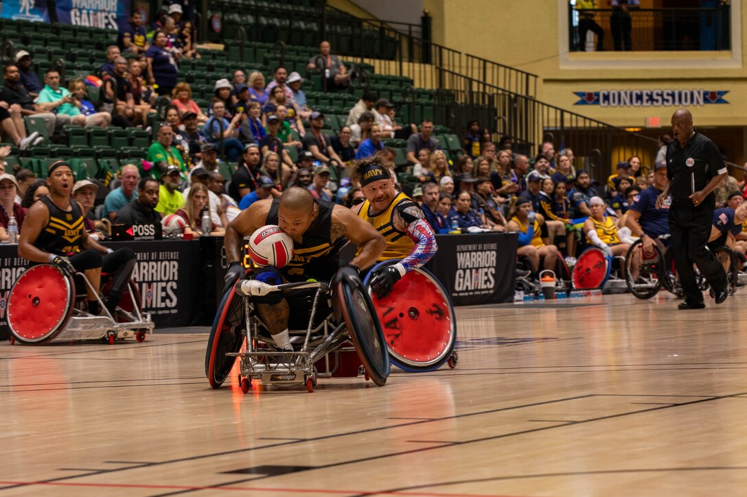 U.S. Army veteran Gene Calantoc races down court with the ball in a wheelchair rugby match
