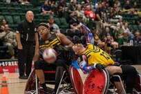 U.S. Army Staff Sgt. Abel Baez steals the ball away from an opponent in a wheelchair rugby match