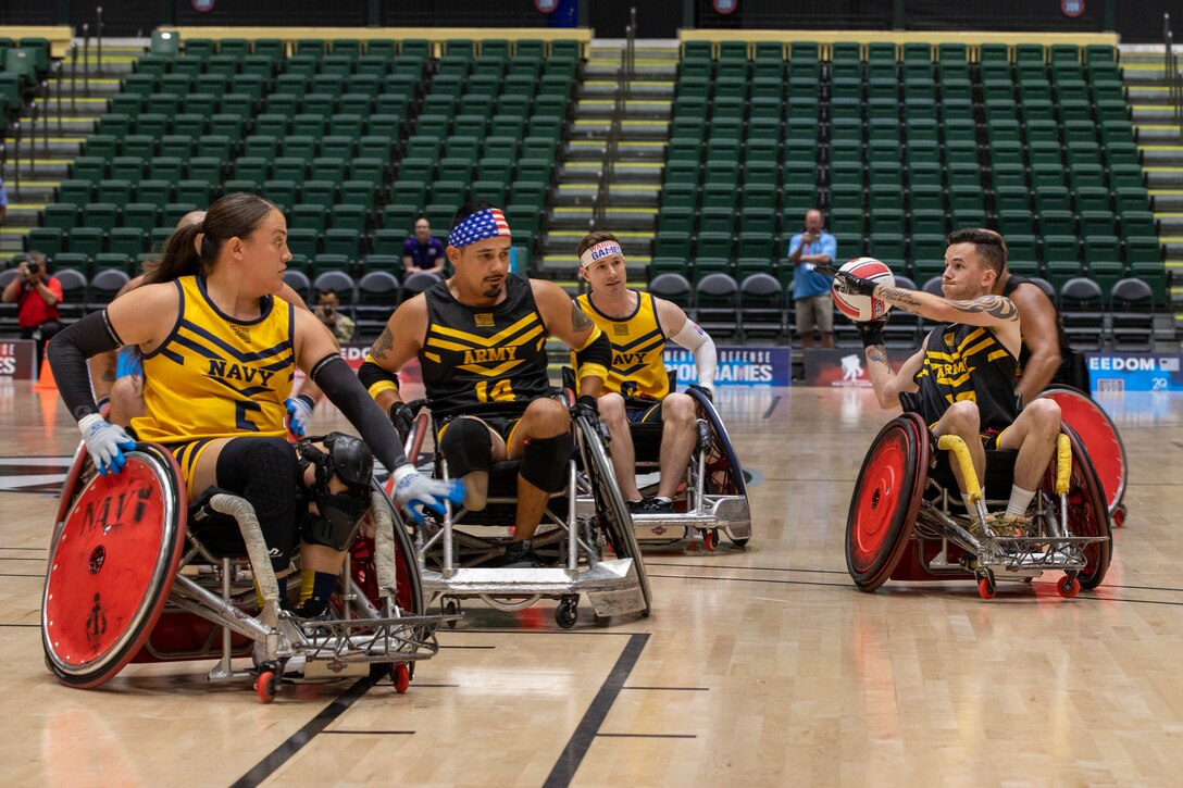 Team Army and Team Navy athletes compete for the bronze medal in a wheelchair rugby match